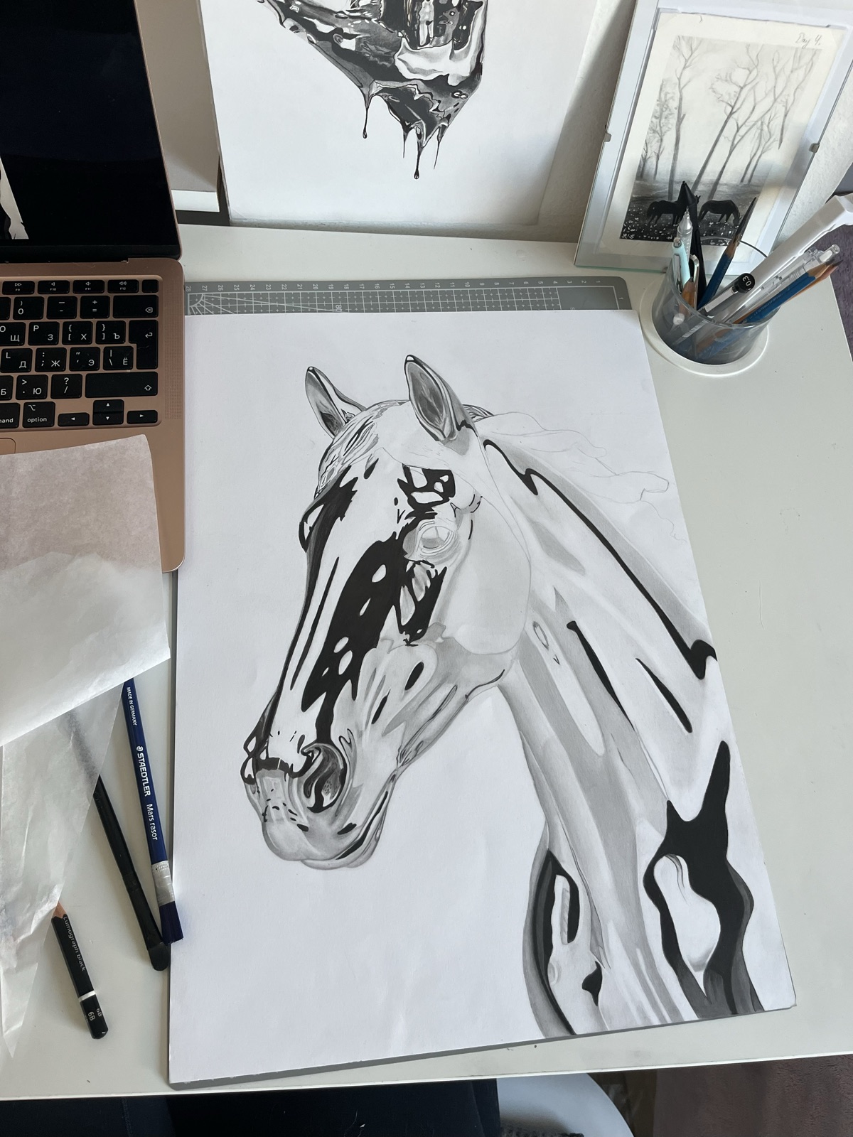 Graphite pencil building up layers on paper — mid-stage of the drawing process