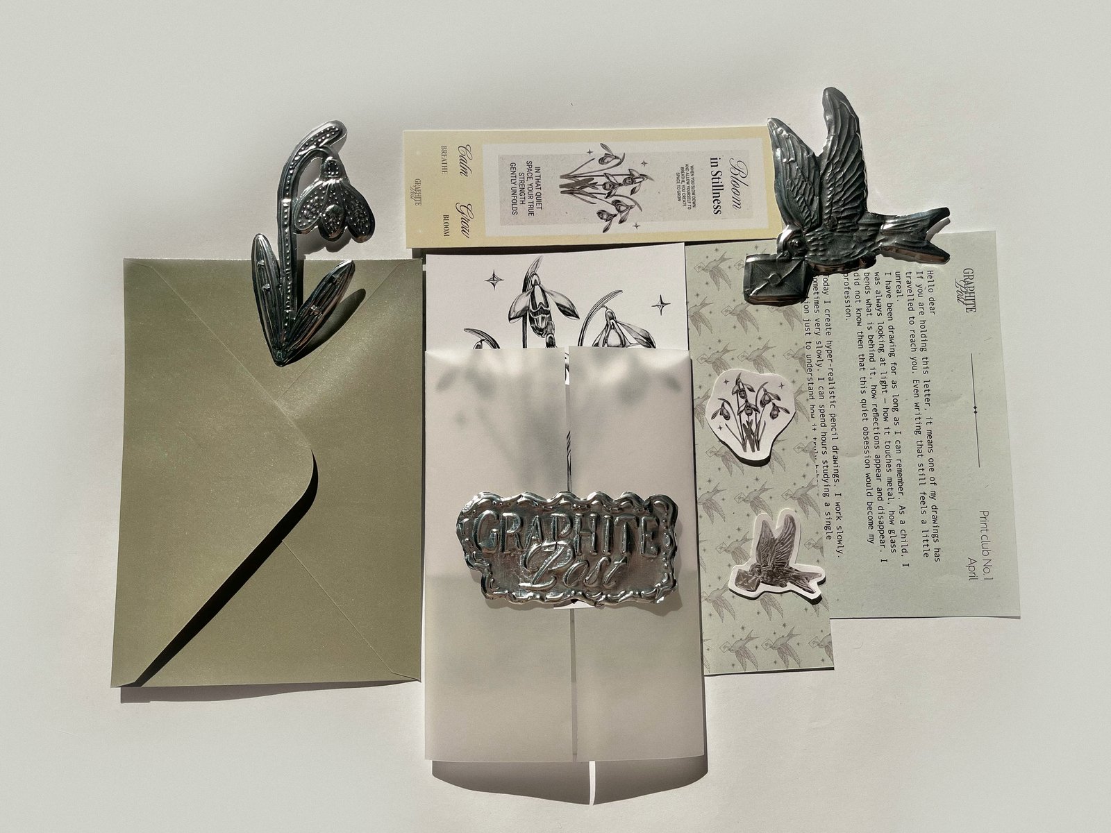 Artistic arrangement of Graphite Post items with envelope and stickers